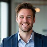 Portrait of Alex Smith, co-founder of Lumina Forge, smiling confidently.