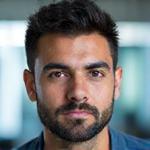 Portrait of Chris Patel, senior full-stack developer at Lumina Forge, looking focused.